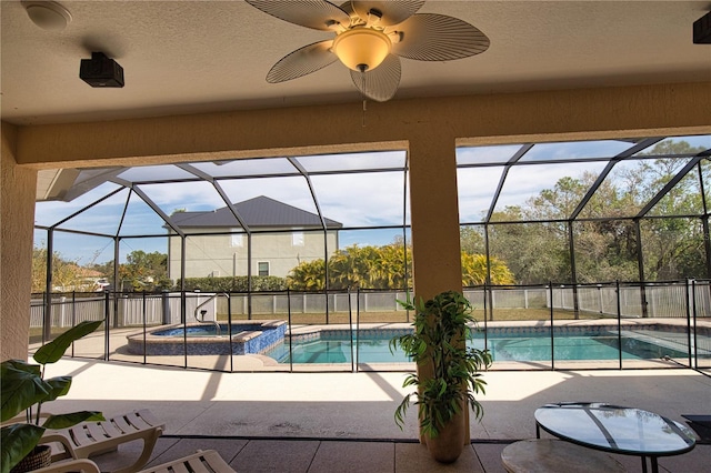 view of swimming pool featuring an in ground hot tub, ceiling fan, a lanai, and a patio area