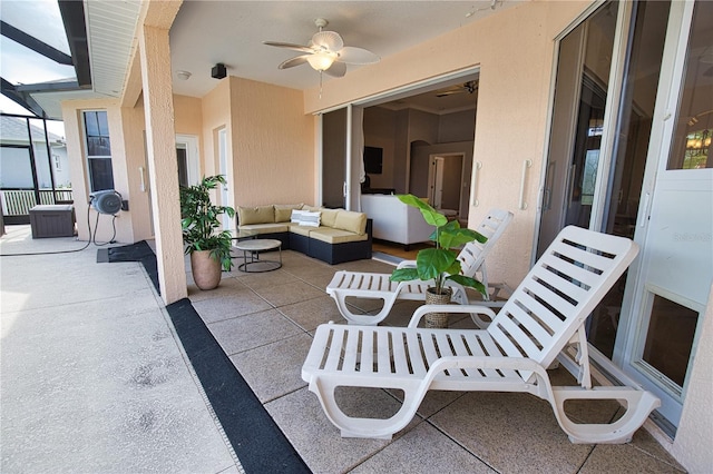 view of patio with ceiling fan, an outdoor living space, and a lanai