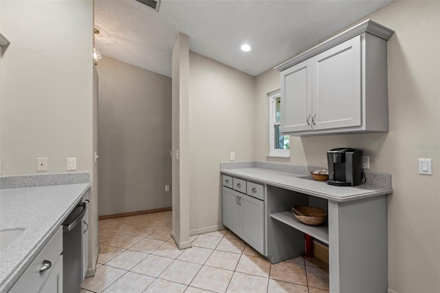 kitchen with light tile patterned floors, a textured ceiling, gray cabinetry, baseboards, and open shelves