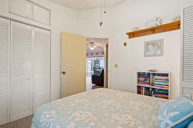 carpeted bedroom with a closet and visible vents