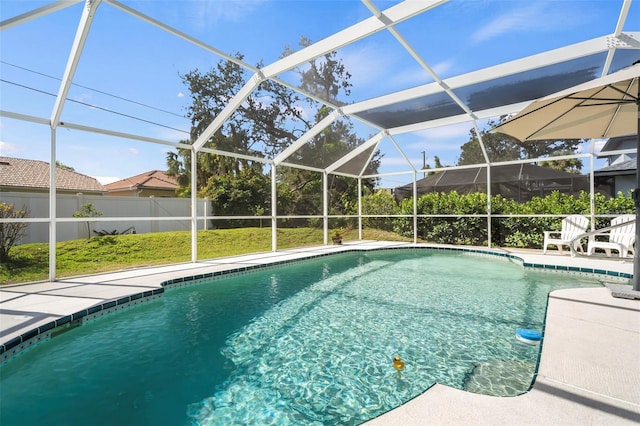 view of pool featuring a lanai, fence, a fenced in pool, and a patio