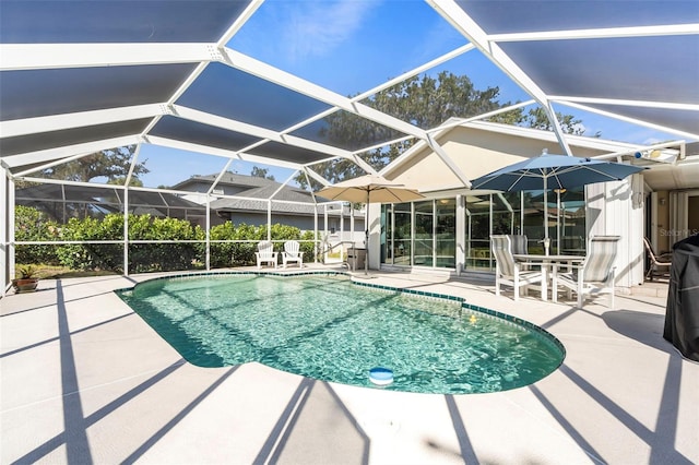 pool with glass enclosure and a patio