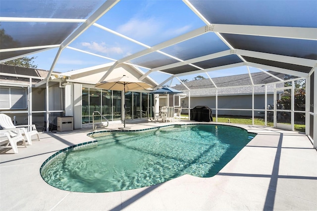 pool featuring a patio area and glass enclosure