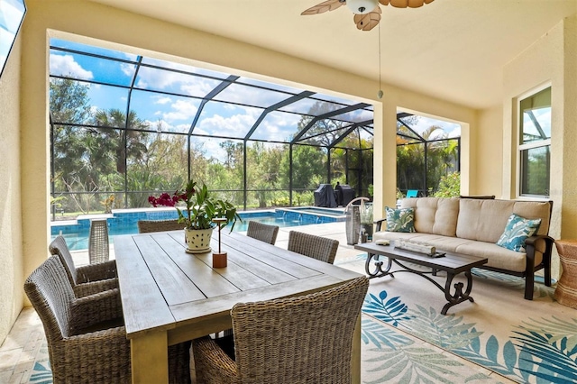 sunroom / solarium featuring ceiling fan and a pool