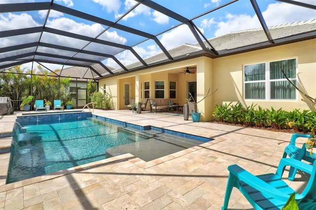 outdoor pool with an outdoor hangout area, a patio area, a lanai, and a ceiling fan