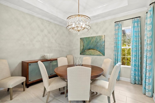 dining area with a tray ceiling, a chandelier, and crown molding