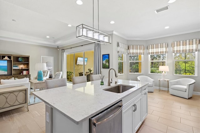 kitchen featuring a sink, visible vents, open floor plan, and dishwasher