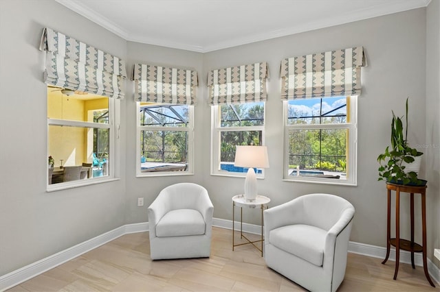 living area featuring baseboards and crown molding