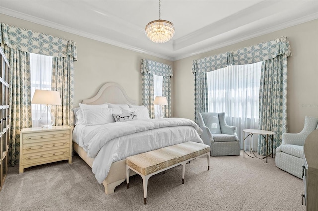 bedroom featuring an inviting chandelier, a raised ceiling, crown molding, and light colored carpet