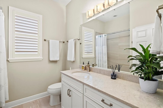 full bath featuring toilet, baseboards, a tile shower, and vanity