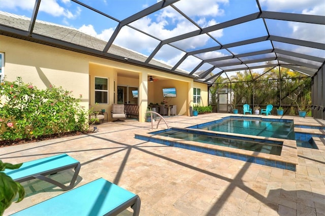 pool featuring a patio area, ceiling fan, and an in ground hot tub