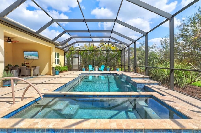 view of swimming pool featuring a patio and an in ground hot tub