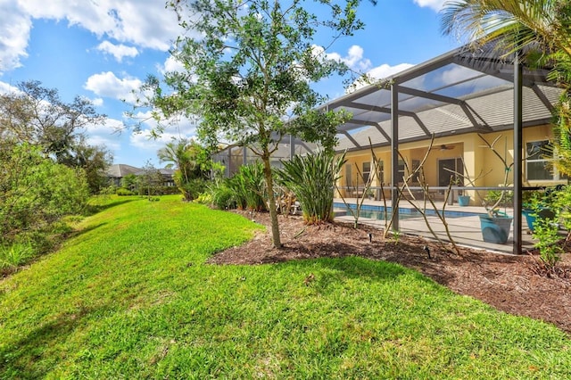 view of yard with glass enclosure, a patio area, and an outdoor pool