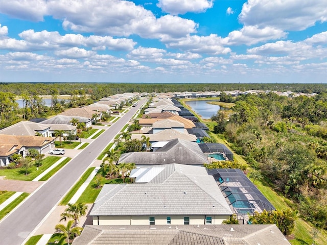 drone / aerial view with a water view and a residential view