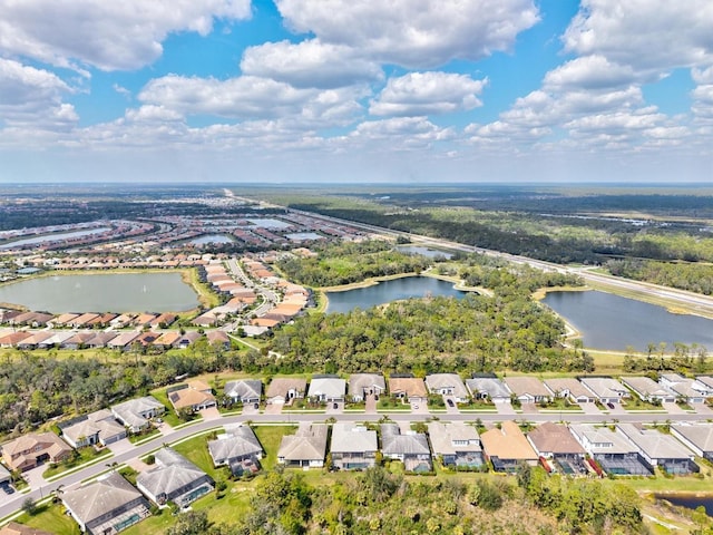 drone / aerial view featuring a water view and a residential view