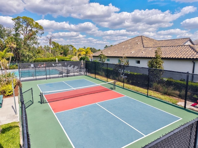 view of sport court featuring fence