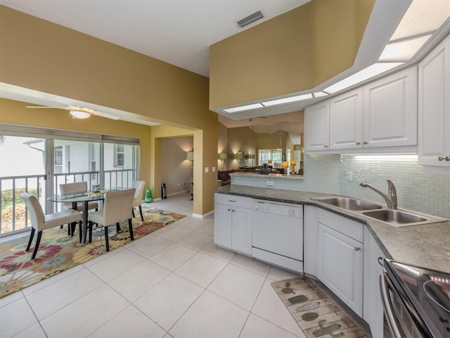 kitchen featuring tasteful backsplash, sink, white cabinets, electric range, and white dishwasher