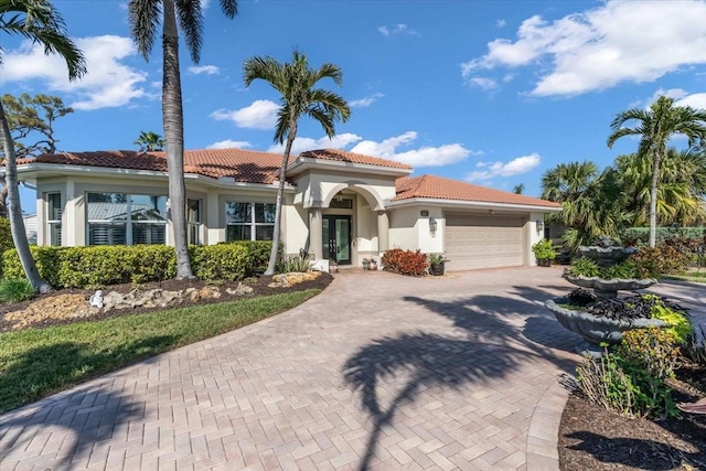 mediterranean / spanish house with a garage