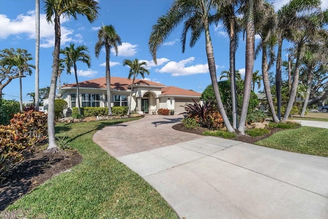 view of front facade with a garage and a front lawn