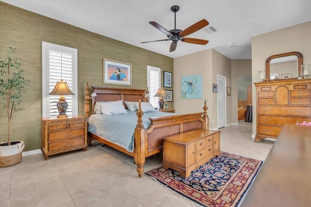 tiled bedroom featuring ceiling fan