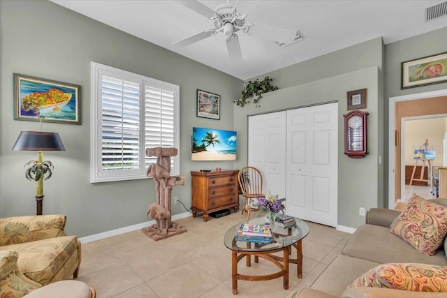 living room featuring light tile patterned floors and ceiling fan