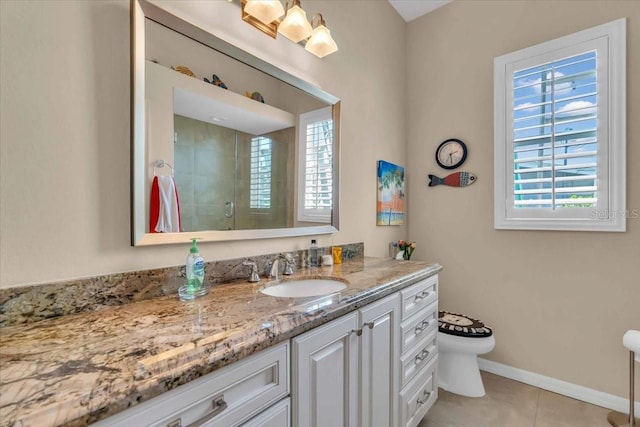 bathroom featuring vanity, tile patterned flooring, a shower with shower door, and toilet