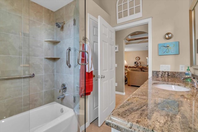 bathroom with tile patterned floors, vanity, and tiled shower / bath combo