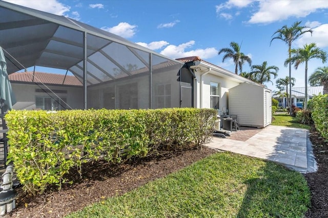 back of house with a lanai and a patio area