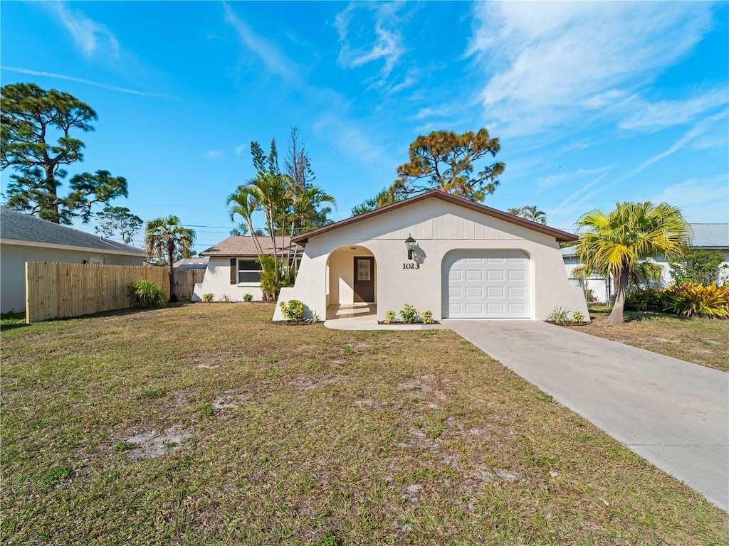 single story home with a garage and a front yard