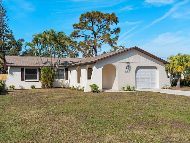 single story home featuring a garage and a front lawn