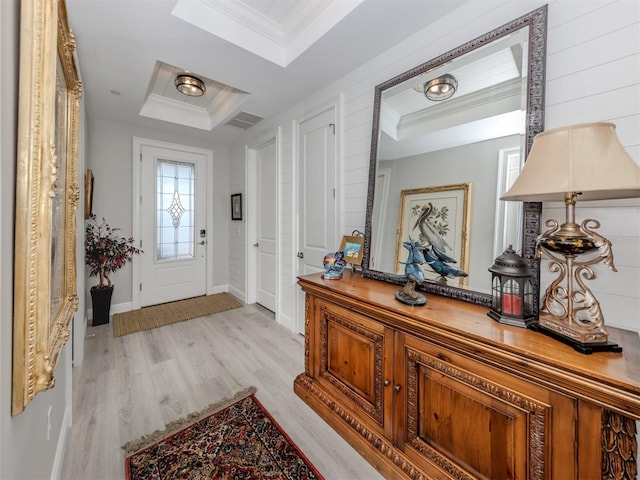 501 Tamiami Trl N Unit 502, Venice, FL 34285 - foyer featuring a raised ceiling, visible vents, ornamental molding, light wood-style floors, and baseboards
