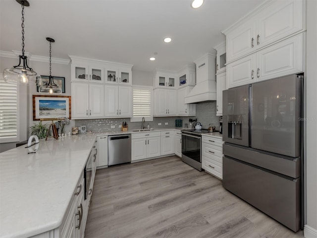 501 Tamiami Trl N Unit 502, Venice, FL 34285 - kitchen featuring a sink, appliances with stainless steel finishes, custom exhaust hood, and white cabinets