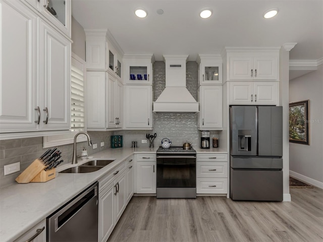 501 Tamiami Trl N Unit 502, Venice, FL 34285 - kitchen featuring white cabinetry, custom exhaust hood, stainless steel appliances, and a sink
