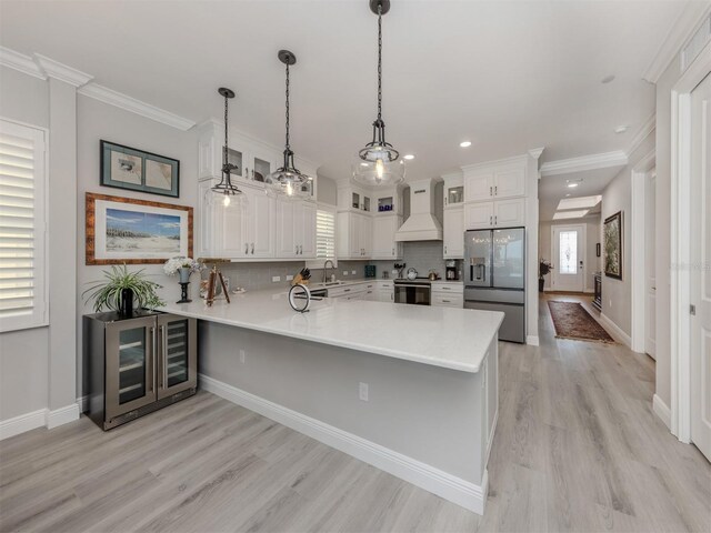 501 Tamiami Trl N Unit 502, Venice, FL 34285 - kitchen featuring electric range oven, a sink, a peninsula, stainless steel fridge, and premium range hood