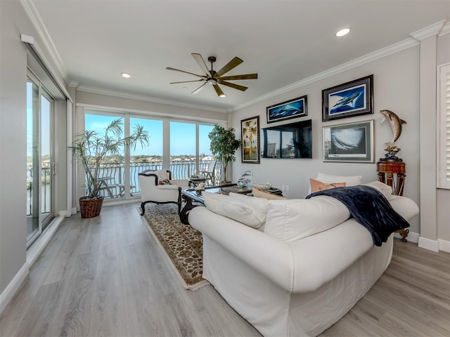 501 Tamiami Trl N Unit 502, Venice, FL 34285 - living area featuring a water view, light wood finished floors, baseboards, and ornamental molding