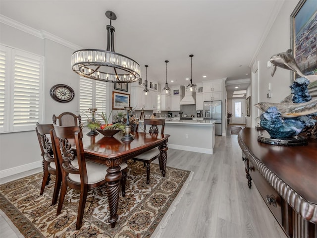 501 Tamiami Trl N Unit 502, Venice, FL 34285 - dining space with a chandelier, baseboards, crown molding, and light wood finished floors