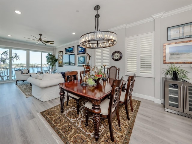 501 Tamiami Trl N Unit 502, Venice, FL 34285 - dining room featuring baseboards, wine cooler, light wood-style flooring, and crown molding