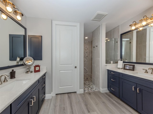 501 Tamiami Trl N Unit 502, Venice, FL 34285 - full bathroom featuring wood finished floors, walk in shower, and a sink