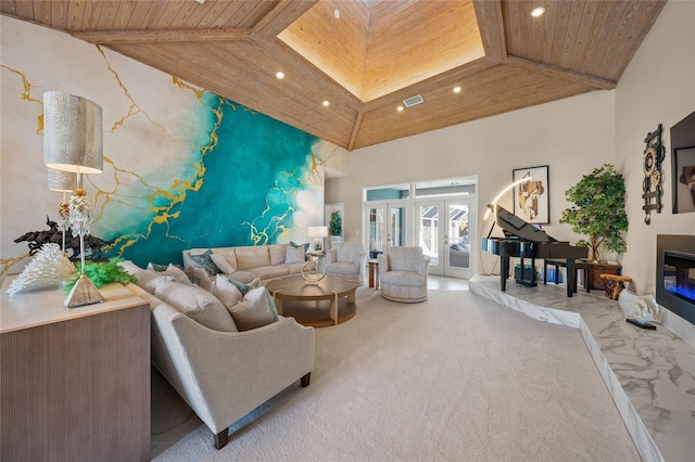 living room featuring carpet floors, a skylight, high vaulted ceiling, and wood ceiling