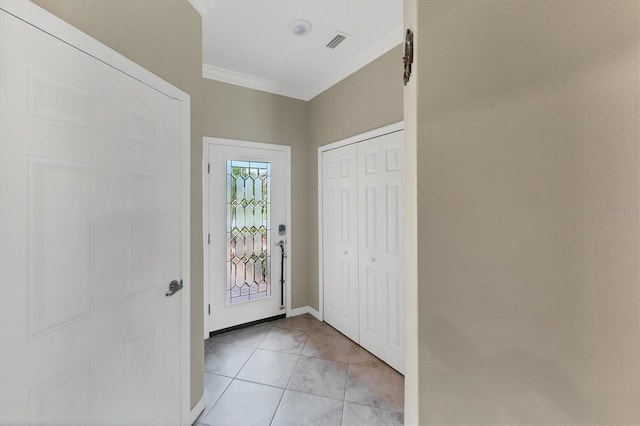 entrance foyer with ornamental molding and light tile patterned floors