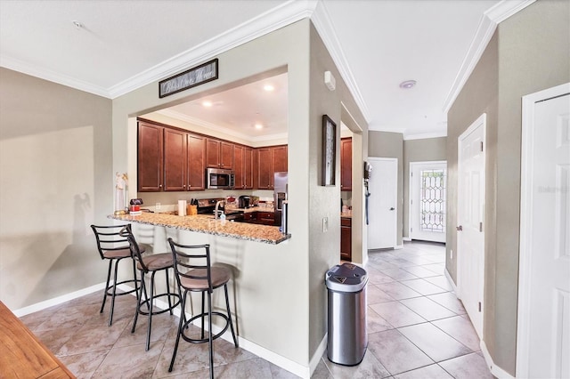 kitchen featuring light tile patterned floors, a breakfast bar area, stainless steel appliances, light stone countertops, and kitchen peninsula