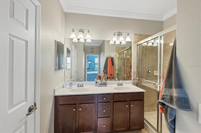 bathroom featuring ornamental molding, vanity, and a shower with shower door