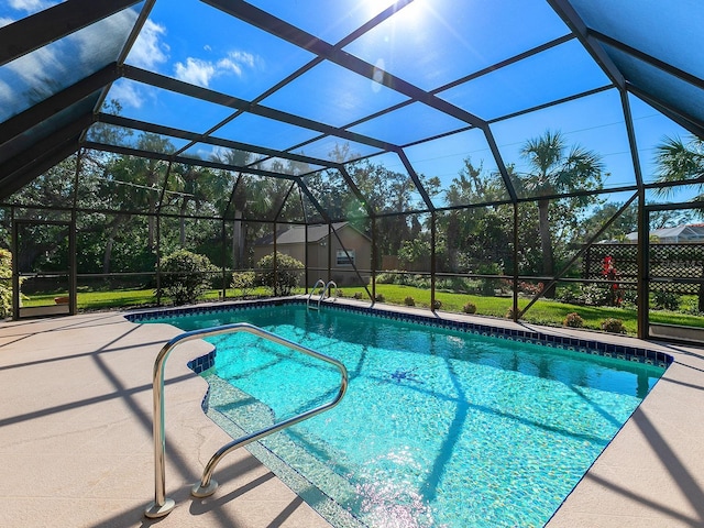 view of pool featuring a lanai, a lawn, and a patio