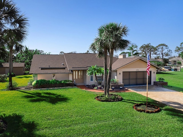 ranch-style house with a garage and a front lawn