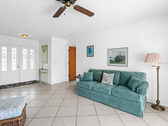 living room with light tile patterned flooring and a textured ceiling