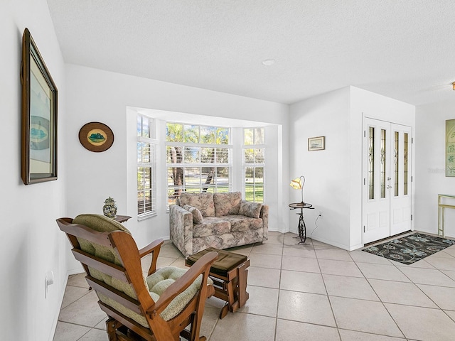 tiled living room featuring a textured ceiling