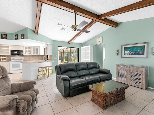 living room featuring sink, vaulted ceiling with beams, light tile patterned floors, ceiling fan, and a textured ceiling