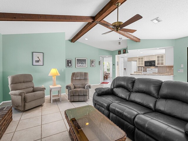 tiled living room with ceiling fan, a textured ceiling, and vaulted ceiling with beams