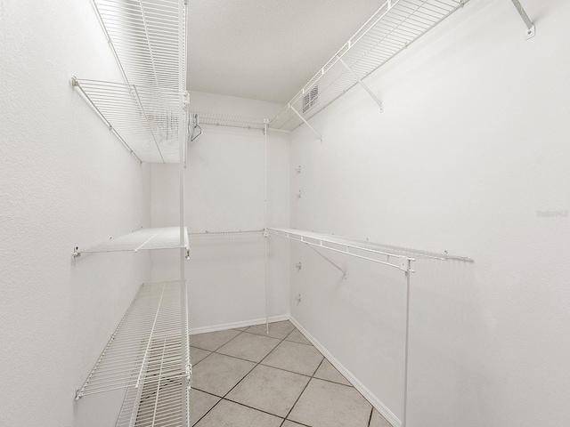 walk in closet featuring light tile patterned floors