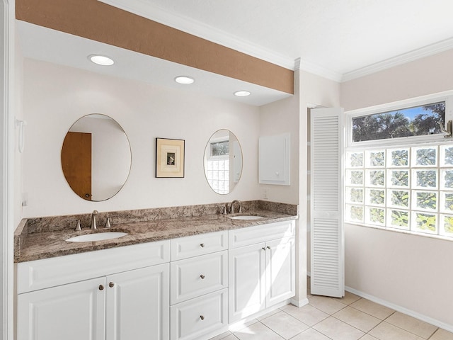 bathroom with tile patterned flooring, vanity, plenty of natural light, and ornamental molding